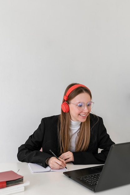 Medium shot woman working with laptop