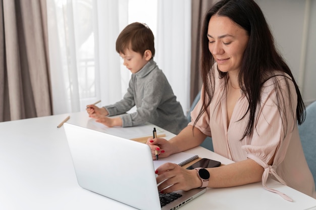 Medium shot woman working with laptop