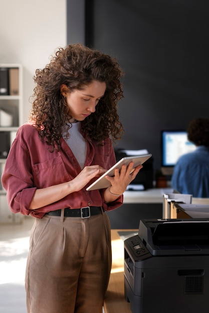 Medium shot woman working with tablet