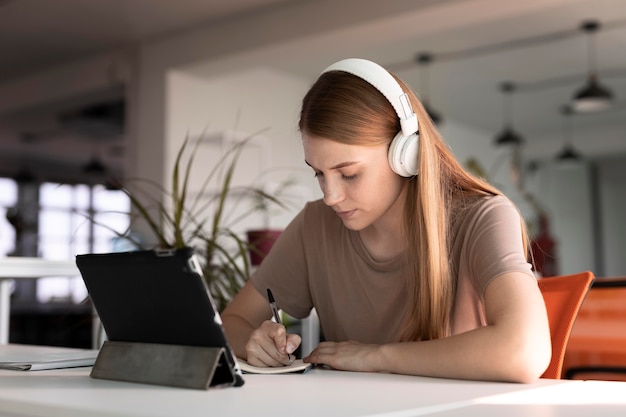 Medium shot woman writing down information