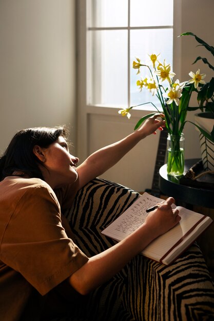 Medium shot woman writing in her journal