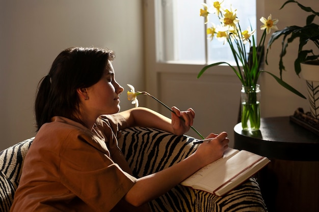 Medium shot woman writing in her journal