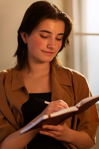 Medium shot woman writing in her journal