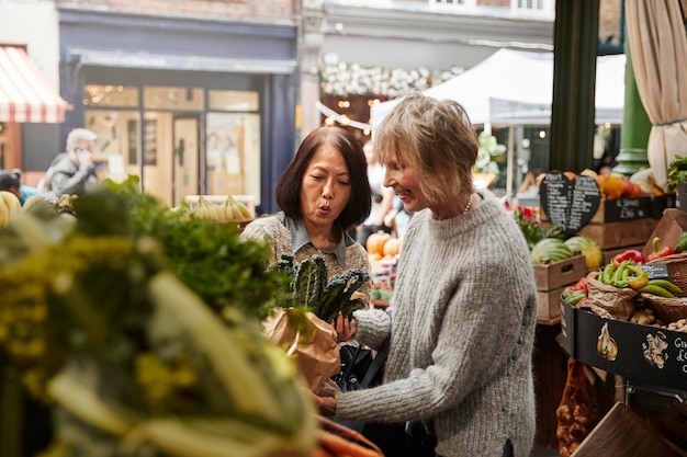 Medium shot women buying healthy food