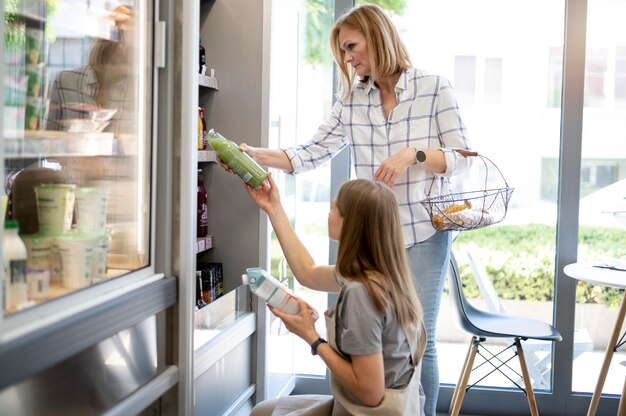 Medium shot women checking products