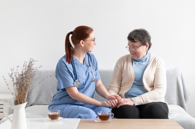 Free photo medium shot women holding hands