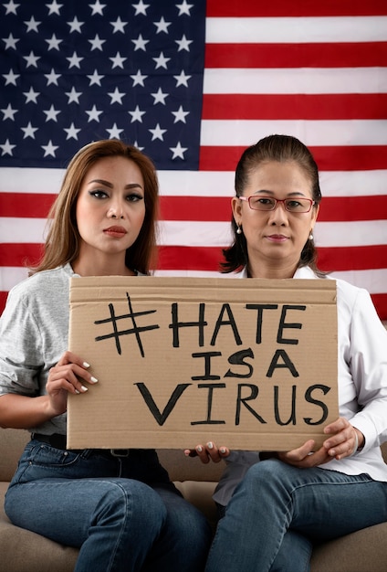 Medium shot women holding placard with message