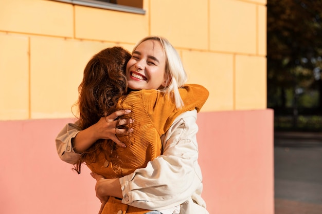 Medium shot women hugging