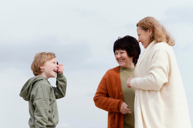 Medium shot women and kid outdoors