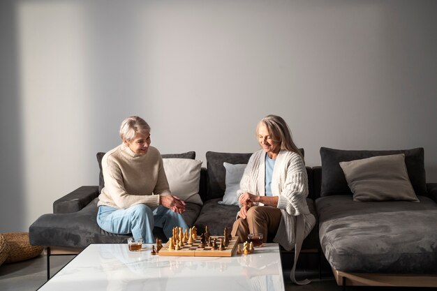 Medium shot women playing chess