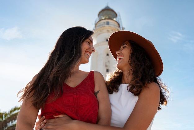 Medium shot women posing with lighthouse