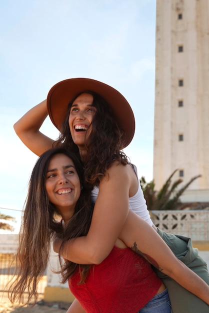 Medium shot women posing with lighthouse