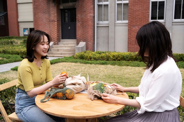 Medium shot women sitting at table