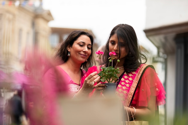 Medium shot women smelling flowers