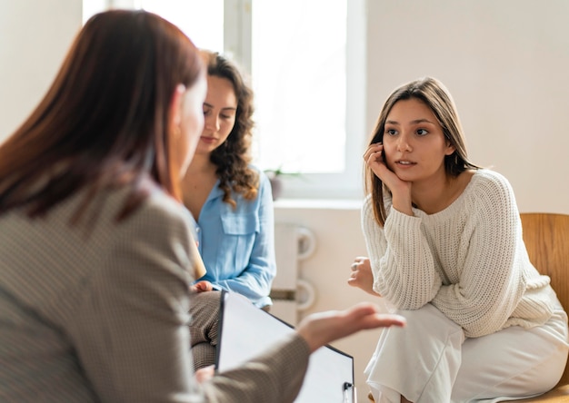 Medium shot women talking at therapy