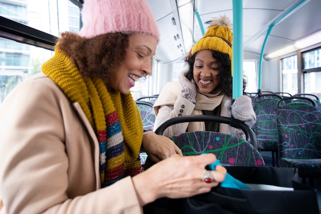 Medium shot women traveling by bus