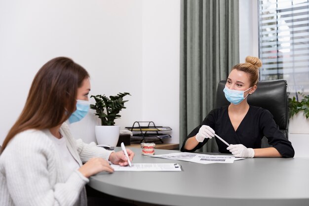 Medium shot women wearing masks