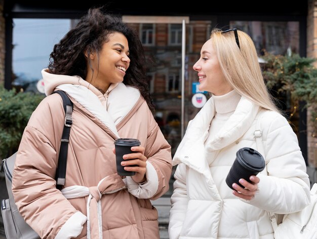 Medium shot women with coffee cups