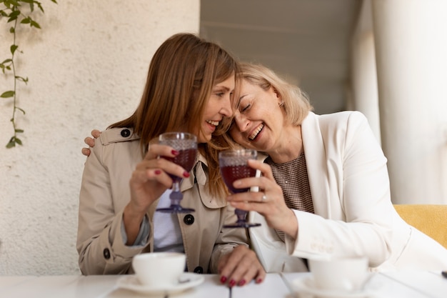 Medium shot women with drinks