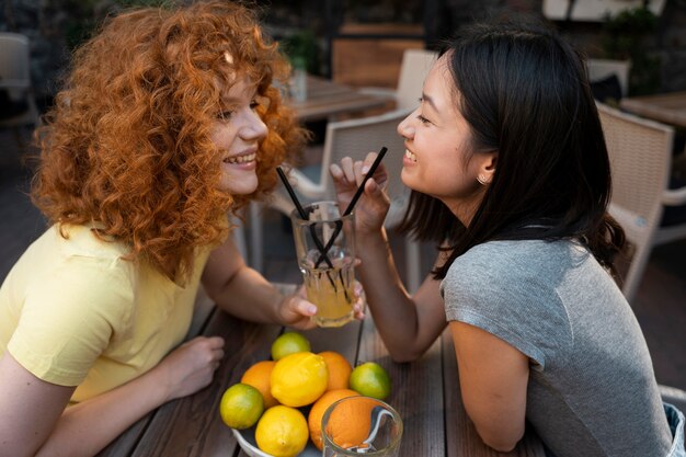 Medium shot women with drinks