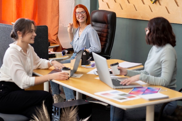 Medium shot women working together