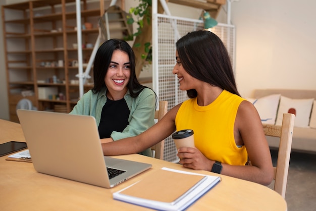 Medium shot women working together