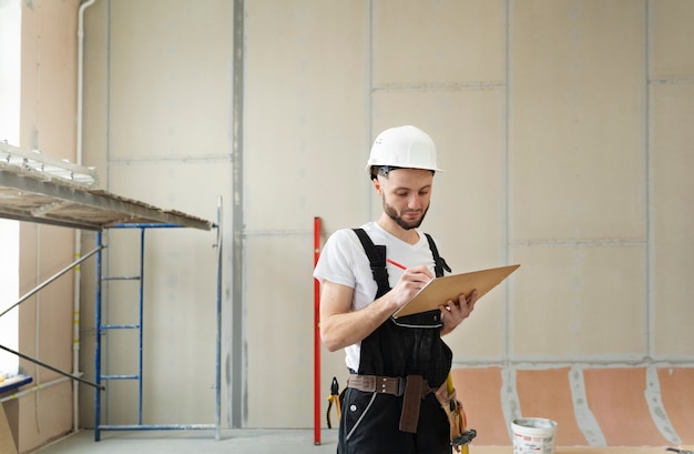 Medium shot worker wearing helmet