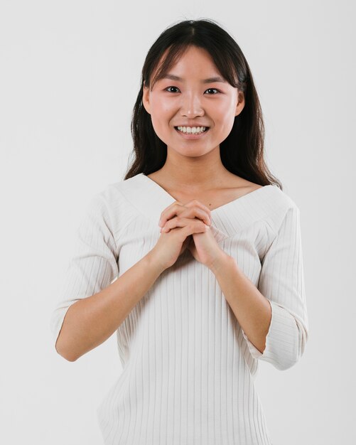 Medium shot young asian woman praying