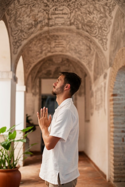 Free photo medium shot young man praying