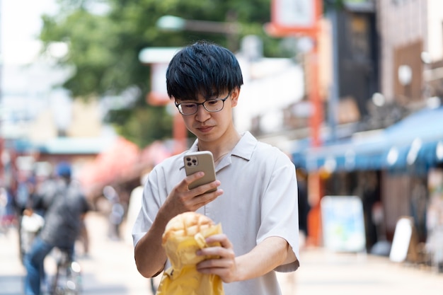 Medium shot young man taking food photo