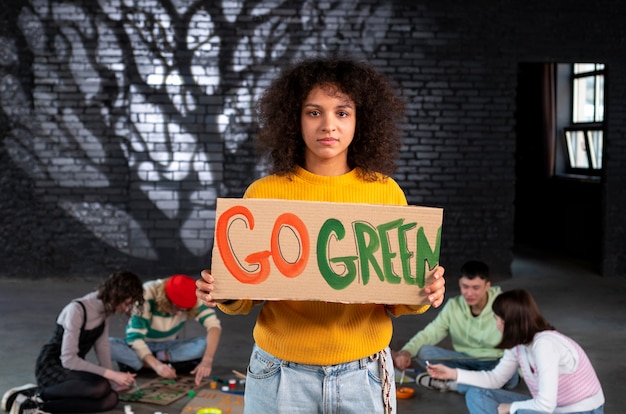 Free photo medium shot young woman holding protest banner