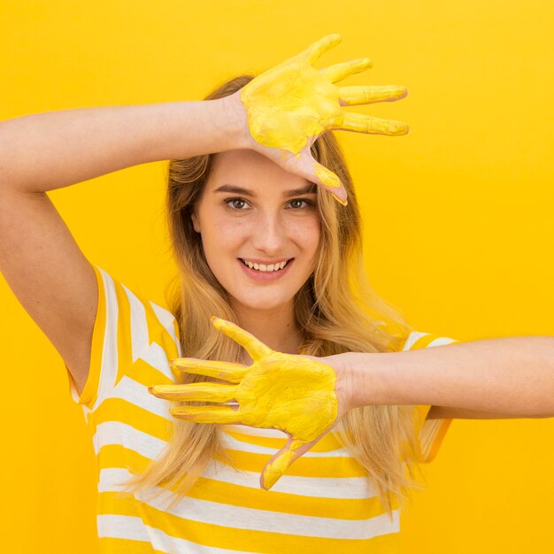 Medium show woman with paint on hands