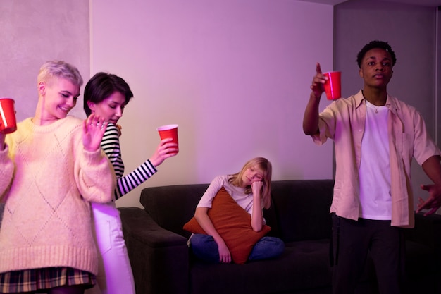 Medium woman sitting alone at party