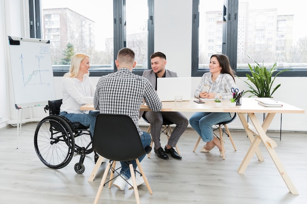 Meeting in the office with woman in wheelchair