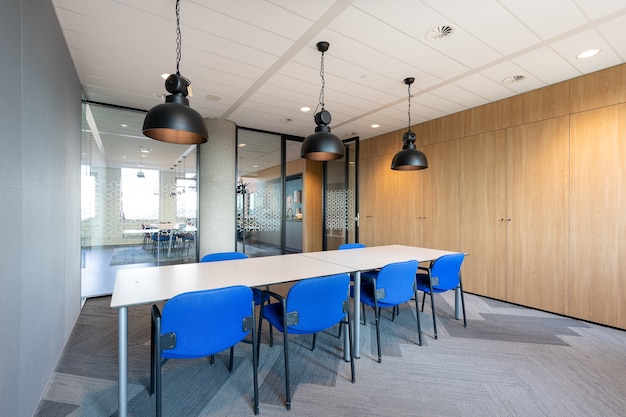 Free Photo meeting room interior of a modern office with a long wooden table and chairs around it