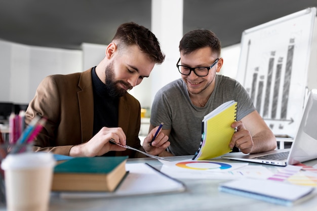 Free Photo men analyzing a graph together at work