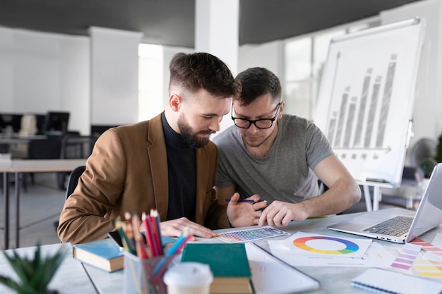 Men analyzing a graph together at work