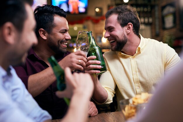 Men chilling with drinks in the pub