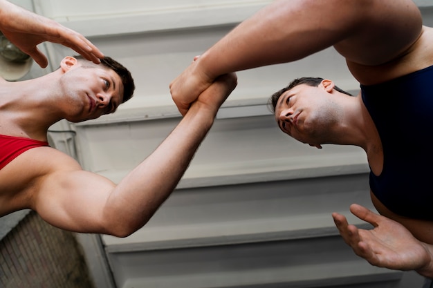 Free photo men demonstrating wrestling combat moves