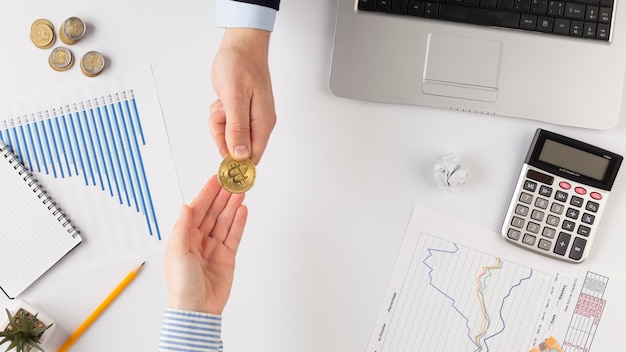 Free photo men exchanging a bitcoin with copy space