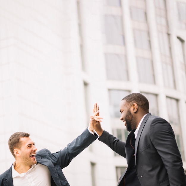 Free Photo men giving high five