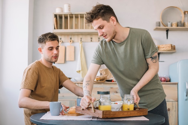 Men having breakfast on dinning table in kitchen