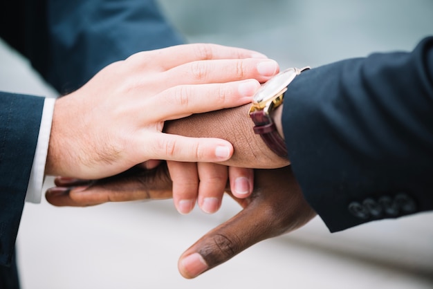 Free photo men holding hands together