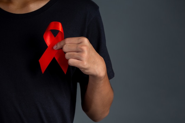 Men holding red ribbons. Conceptual awareness. HIV. World AIDS Day and World Sexual Health Day.