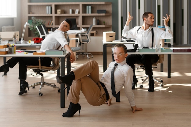 Free photo men performing vogue dance indoors