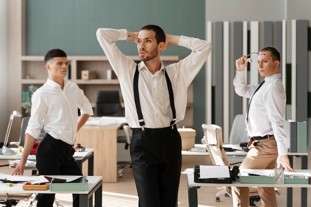 Free Photo men performing vogue dance indoors