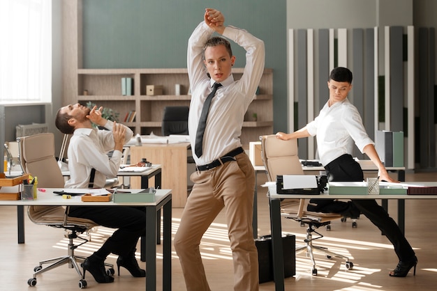 Free photo men performing vogue dance indoors