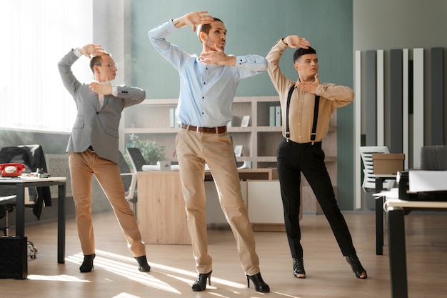 Free photo men performing vogue dance indoors