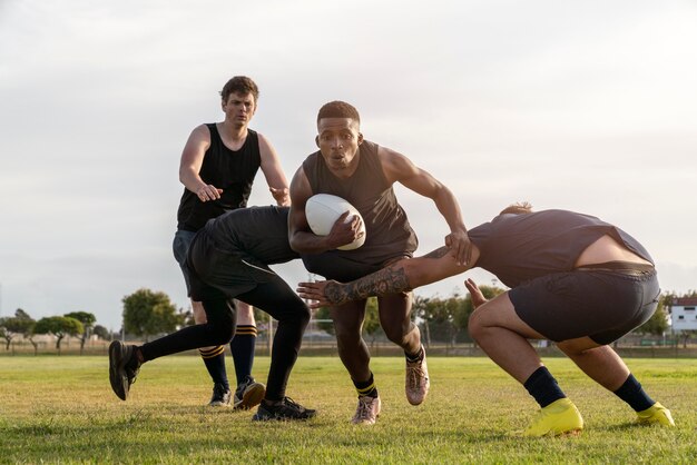 Men playing rugby on the field