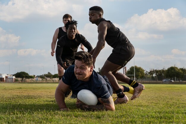 Men playing rugby on the field